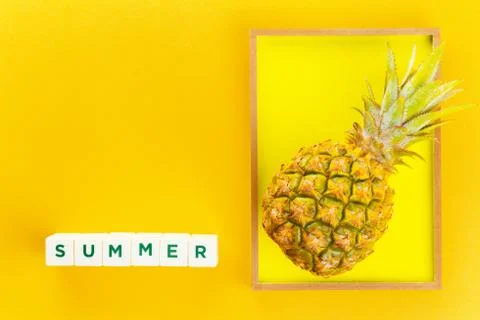 Pineapple in a frame on summer yellow background Stock Photos