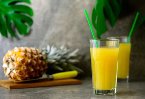 Pineapple freshly squeezed juice in two glasses Stock Photos