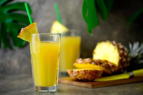 Pineapple freshly squeezed juice in two glasses Stock Photos