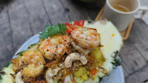 Pineapple Fried Rice has prawns and roasted cashew nuts. This Pineapple Fried Stock Footage 326281237