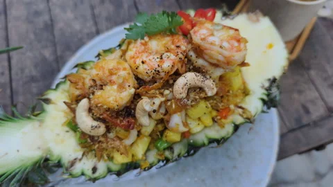 Pineapple Fried Rice with prawns and cashews is exotic. Tasty Pineapple Fried Stock Footage 325421992