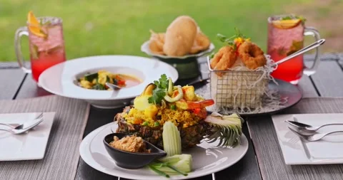 Pineapple fried rice with seafood served on outdoor restaurant table Видео 327736243