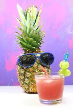 Pineapple fruit with blue  sunglasses drinks fruity cocktail Stock Photos