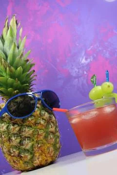Pineapple fruit with blue  sunglasses drinks fruity cocktail Stock Photos