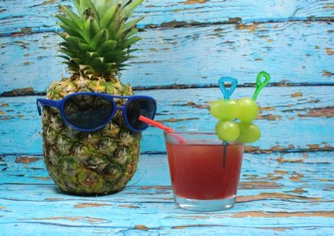 Pineapple fruit with blue  sunglasses drinks fruity cocktail Stock Photos