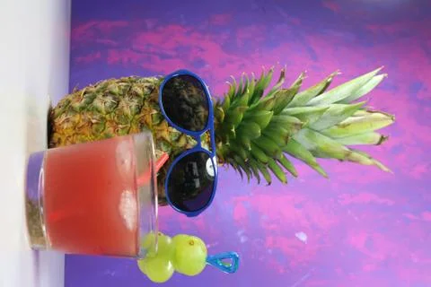 Pineapple fruit with blue  sunglasses drinks fruity cocktail Stock Photos