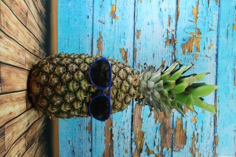 Pineapple fruit with blue  sunglasses Stock Photos
