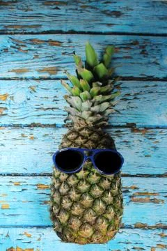 Pineapple fruit with blue  sunglasses Stock Photos