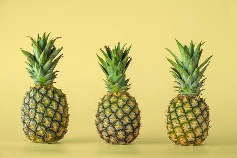 Pineapple fruit isolated on yellow background. Stock Photos