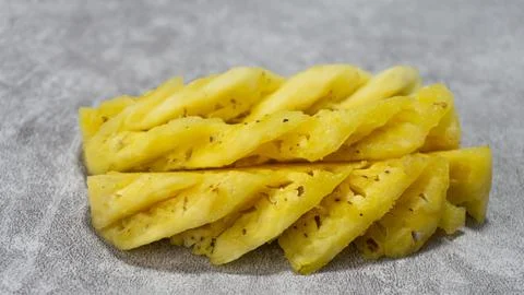 Pineapple fruit slices on gray background with concrete texture Foto stock