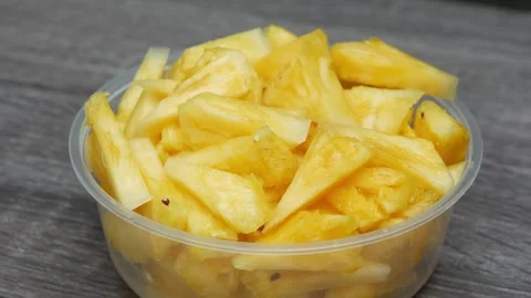 Pineapple fruit slices in transparent plastic container, concept for health.. Stock Footage 244915521