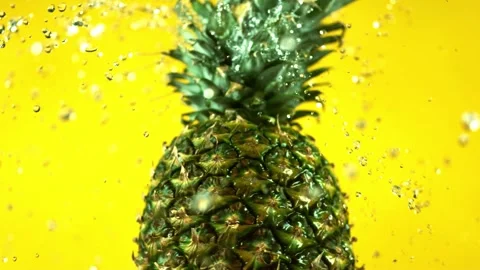 Pineapple fruit washing with water drops splashing isolated background Stock Footage 327573452