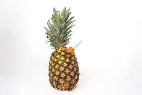 Pineapple, fruit on a white background, with a straw in the spout to be abl.. Stock Photos