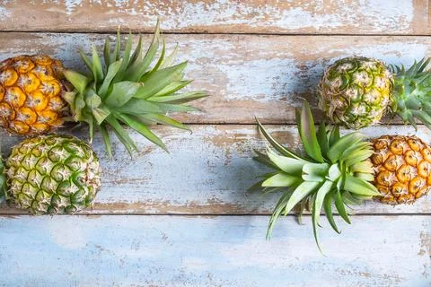 .Pineapple fruit on a wooden background Stock Photos