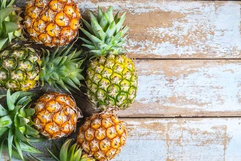 .Pineapple fruit on a wooden background Stock Photos
