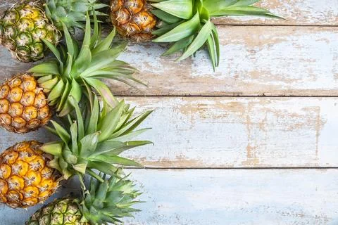 .Pineapple fruit on a wooden background Stock Photos