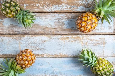 .Pineapple fruit on a wooden background Stock Photos