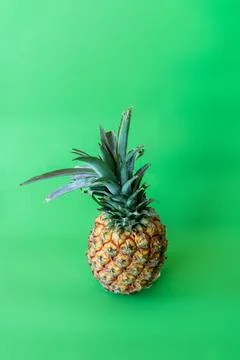 Pineapple on a green background. Tropical fruit. Pineapple on a green background Stock Photos