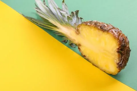 Pineapple half on bright background creative layout, copy space. Flat lay pat Stock Photos