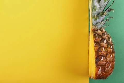 Pineapple half on bright background creative layout, copy space. Flat lay pat Stock Photos