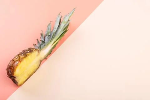 Pineapple half on bright background creative layout, copy space. Flat lay pat Stock Photos