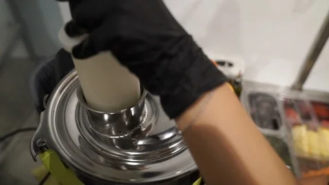 Pineapple Inserted Into Juicer by Gloved Hand Stock Footage 87454772