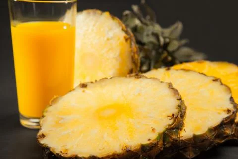 Pineapple juice on black background Stock Photos