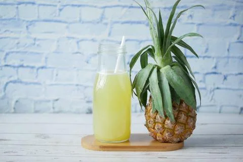 Pineapple juice in a bottle on table Stock Photos