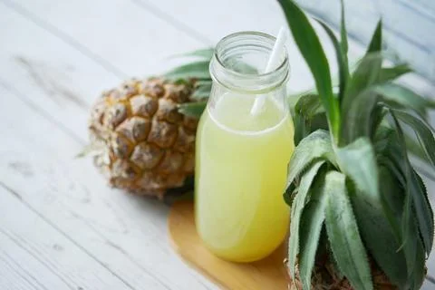 Pineapple juice in a bottle on table Stock Photos