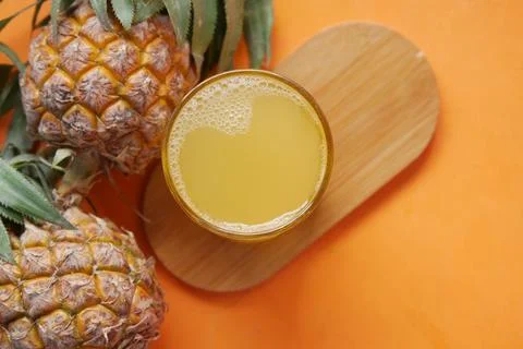 Pineapple juice in a bottle on table Stock Photos