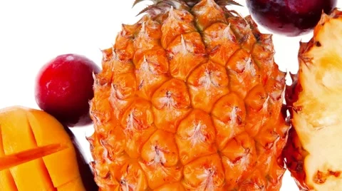 Pineapple mango and red plums isolated over white background Vídeos de archivo 48164240
