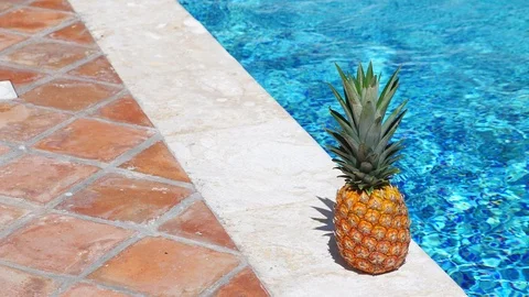 Pineapple near swimming pool 動画素材 104994856