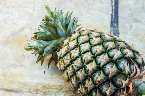 Pineapple on the old floor. Stock Photos