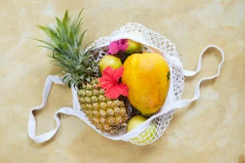 Pineapple Papaya in Eco String Bag Top Down View Stock Photos