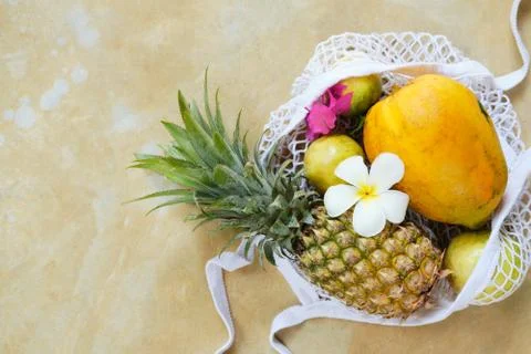 Pineapple Papaya in Eco String Bag Top Down View Stock Photos