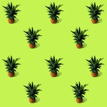Pineapple pattern on a green background, background, screen saver on the phon Stock Photos