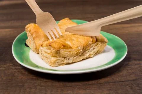 Pineapple pie on white plate with fork and knife Stock Photos