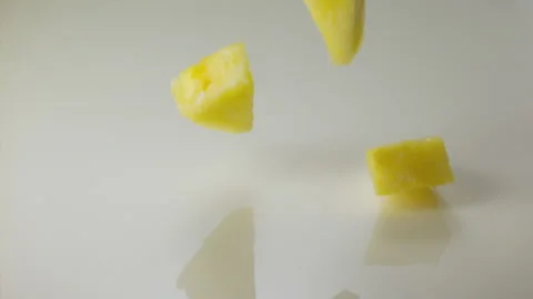 Pineapple pieces falling in milk and splashing Stock Footage 149434146