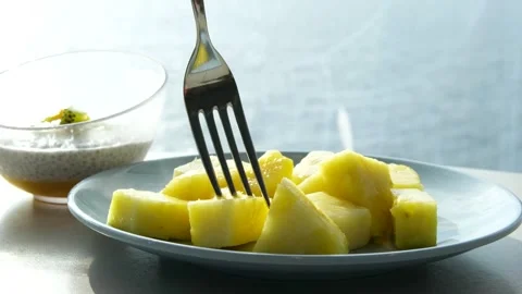 Pineapple pieces fork cut the pineapple rings into pieces. Cooking with canned Stock Footage 319782855