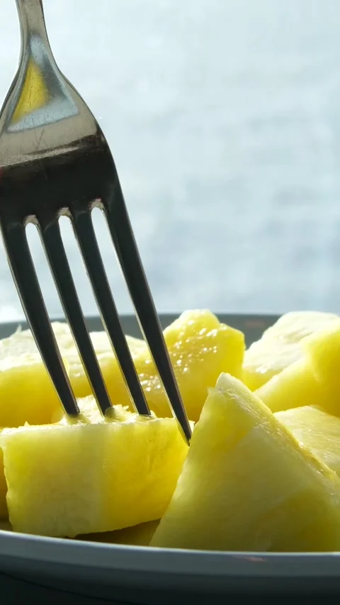 Pineapple pieces fork cut the pineapple rings into pieces. Cooking with canned Stock Footage 323923474
