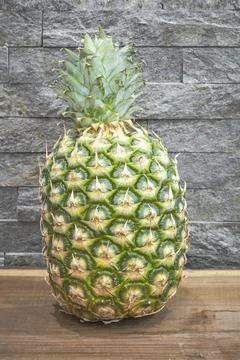 Pineapple placed on the table Stock Photos