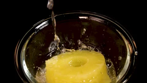 Pineapple Ring Dropped Into Glass Bowl With Splash Stock Footage 313723034