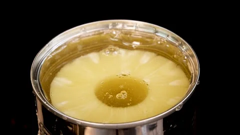 Pineapple Ring Dropped Into Open Can With Splash Stock Footage 313722128