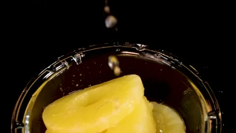 Pineapple Rings Dropping Into Glass Bowl With Splash Stock Footage 314086586
