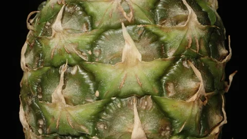Pineapple rotates on a black background, texture close-up. Stock Footage 221970517
