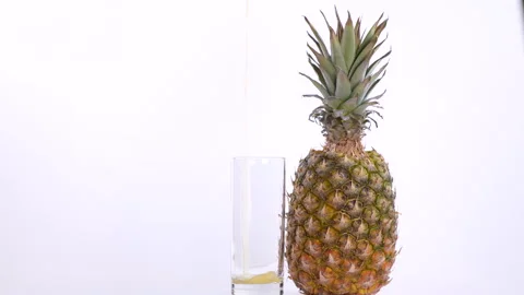 Pineapple Rotating and Juice Poured Into A Glass Stock-Footage 130482729