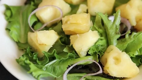 Pineapple Salad mixed green salad leaves and pineapple chunks food preparation Stock Footage 341160023