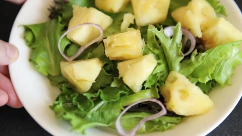 Pineapple Salad mixed green salad leaves and pineapple chunks food preparation Stock Footage 341160025