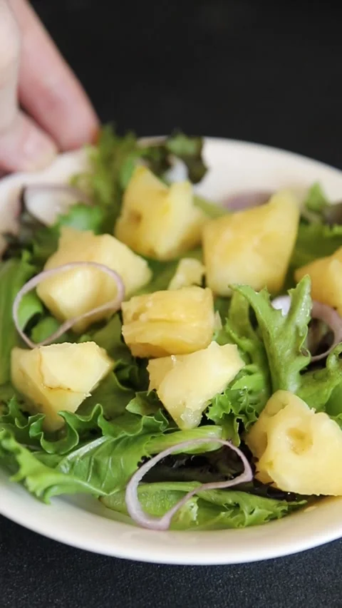 Pineapple Salad mixed green salad leaves and pineapple chunks food preparation Stock Footage 341160041