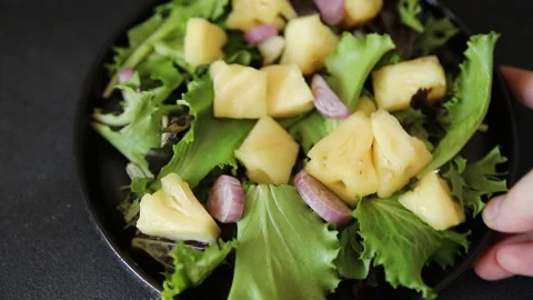 Pineapple Salad mixed green salad leaves and pineapple chunks food preparation Stock Footage 341160058